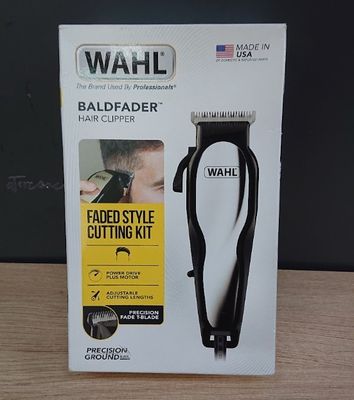 the box is open on a table with a hair clipper in it