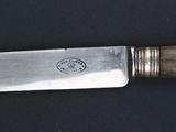 a knife that is laying on a black surface