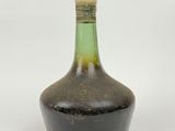 an image of a brown and green glass bottle with a cork stopper