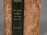 an old book sitting on top of a table next to a gray background