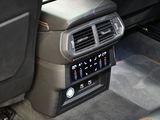 a car dashboard with a radio and a remote control