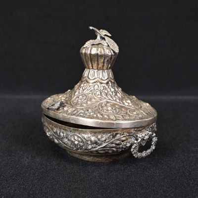 an ornate silver box with a bird on top of it