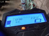 a close up of a motorcycle with a clock on it