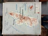 a map on a table with a person standing next to it