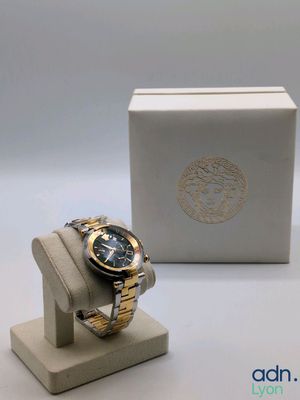 an image of a watch sitting on a stand next to a box