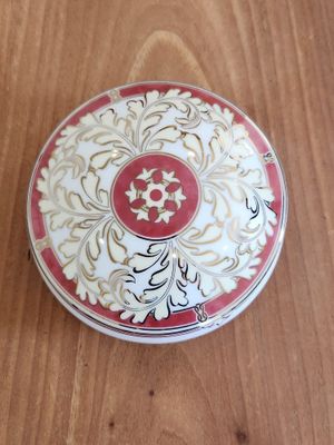 a red and white box sitting on a wooden table