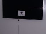 a large flat screen tv mounted on the wall in the room
