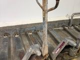 a small hand truck with a fork on the back