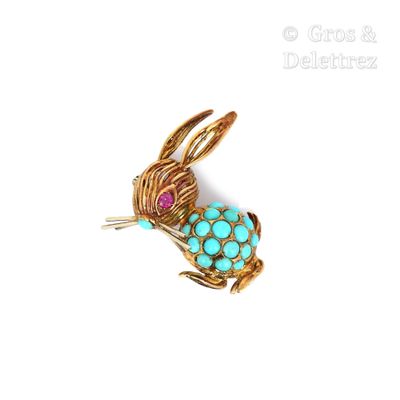 une image représentant une broche en forme de lapin ornée de pierres turquoise et roses