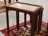 two tables that are sitting on a rug in a room