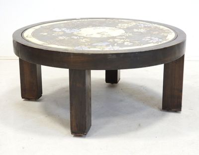 a round table with a marble top and wooden legs