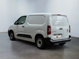 the white van is parked in the empty room of the building