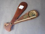 a wooden paddle with a clock on it on the floor