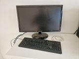 an image of a computer monitor and keyboard on a desk