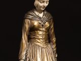a statue of a woman sitting on a bench