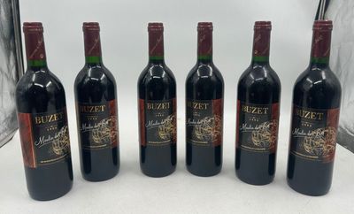 six bottles of wine are lined up on a table