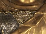 a statue of a man holding a sword and shield