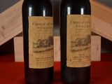 two bottles of wine sitting next to each other on a table