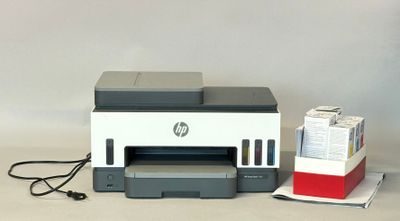 a printer that is sitting on a table next to a box