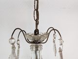 a chandelier with a glass shade hanging from the ceiling