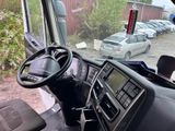 a view of a car from inside of a bus