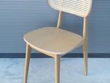 une chaise en bois posée devant un mur