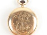 an image of a gold pocket watch with a black face