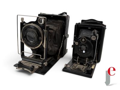 two old cameras sitting next to each other on a white surface