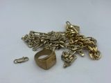 a close up of a gold chain with a ring on it