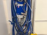 a blue and yellow machine and a yellow bucket on the floor