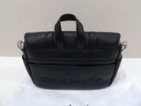 a close up of a black bag on a white cloth