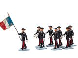 toy figurines of men in uniform holding a flag and a flag pole