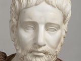 marble bust of a man with a beard wearing a brown shirt