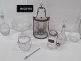 a white table with a lot of glass items on it
