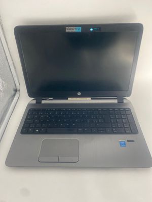 an open laptop computer sitting on top of a white table