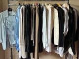 a lot of clothes hanging on a rack in a room