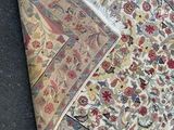 a pile of carpet on the ground next to a pair of scissors