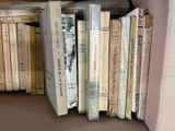 a lot of books that are sitting on a shelf