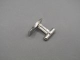 a close up of a pair of screws on a gray surface