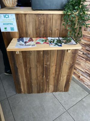 a wooden counter with a plant on top of it