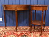 pair of antique mahogany side tables on a rug in front of a blue wall
