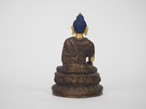 a statue of a buddha sitting on top of a table