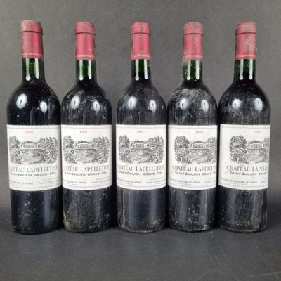 four bottles of wine are lined up on a table