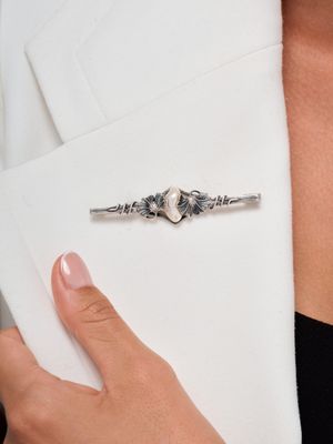 woman wearing a white blazer jacket with a silver ring on it