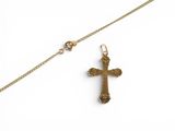gold plated cross pendant with a chain on a white background