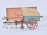 a toy horse pulling a wagon with a man on it