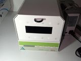 a microwave sitting on top of a table next to a box