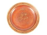 a brown plate with a picture of a dragon on it