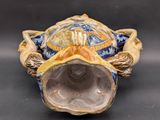 a small ceramic turtle sitting on top of a table