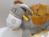 a stuffed donkey that is sitting on a wooden sled